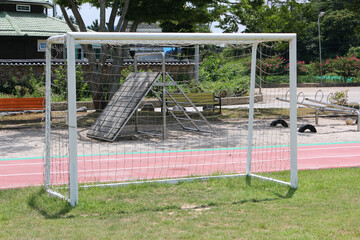 Fototapeta premium Soccer football field near urban school building
