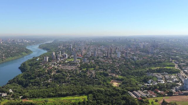 Aerial drone footage advancing over Foz do Igua&ccedil;u with Paran&aacute; River and Ciudad del Este visible.
