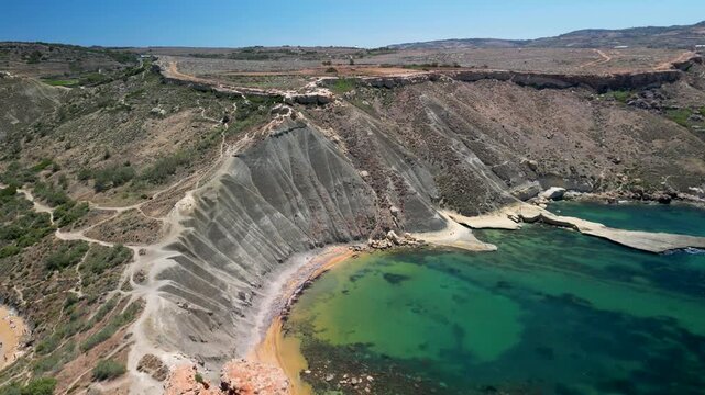 aerial view of Qarraba Bay, Malta, dramatic cliffs and turquoise water, no people