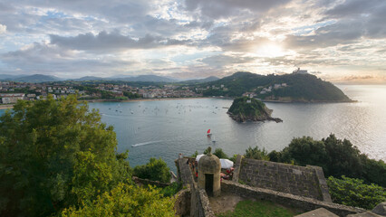 Fototapeta premium Sunset view of La Concha bay with Santa Clara island from Monte Urgull in San Sebastian, Basque Country, Spain