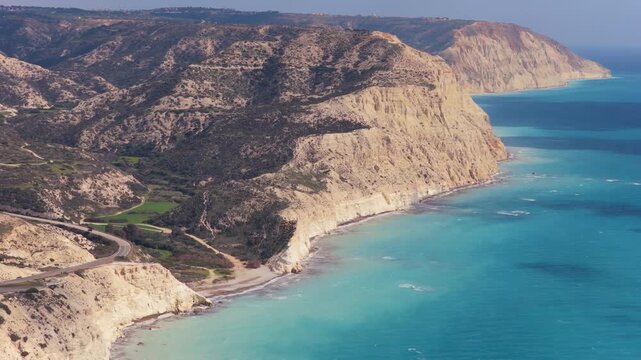 Aerial drone view of dramatic white cliffs meeting the turquoise Mediterranean Sea in Cyprus