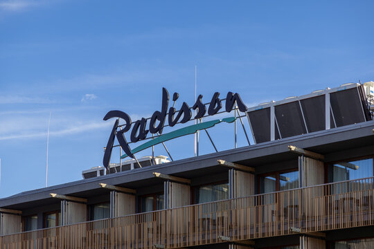 Szklarska Poreba, Poland - December 16, 2025: Radisson hotel sign on modern building rooftop under blue sky, symbolizing global travel and premium hospitality