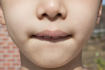 Fototapeta premium This is the face of an Asian child with tightly closed lips.