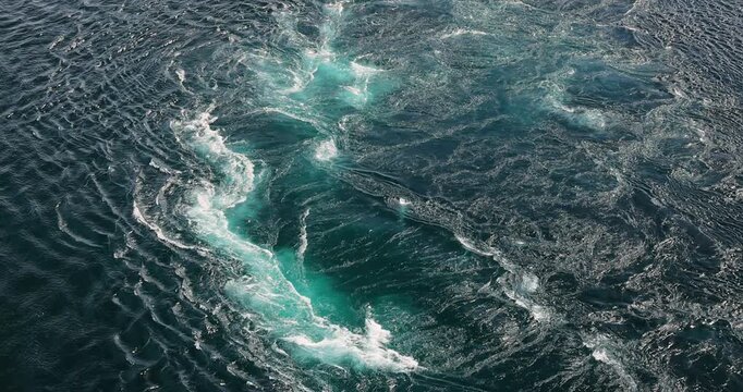 Blue waves of water of the river and the sea meet each other during high tide and low tide.