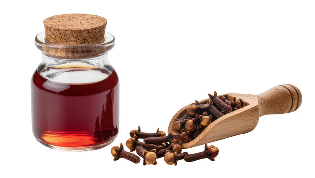 Clear glass jar filled with dark brown clove oil, wooden scoop overflowing with cloves