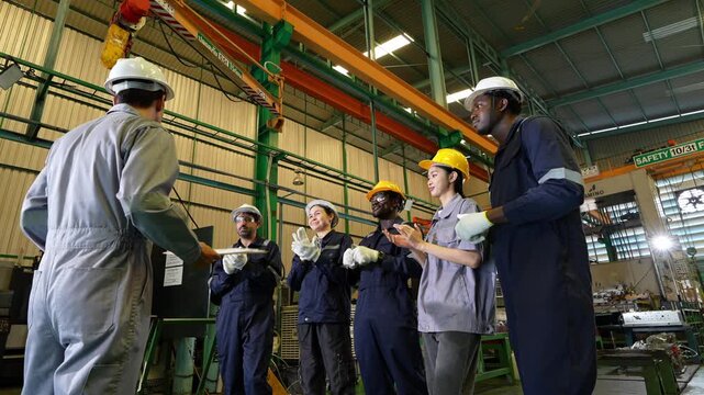 Team meeting on industrial safety practices manufacturing plant group discussion indoor environment close-up view workplace culture