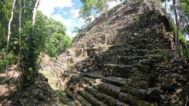 Cinematic travel video of La Danta pyramid rising above the El Mirador jungle, epic Mayan ruins landscape Guatemala Central America