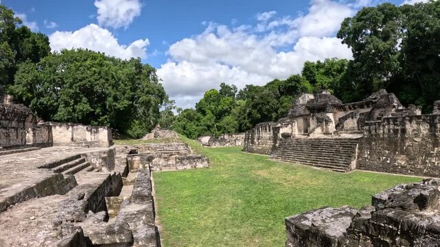Epic jungle landscape with ancient Mayan pyramids in Tikal Guatemala, cinematic archaeological ruins travel video Central America