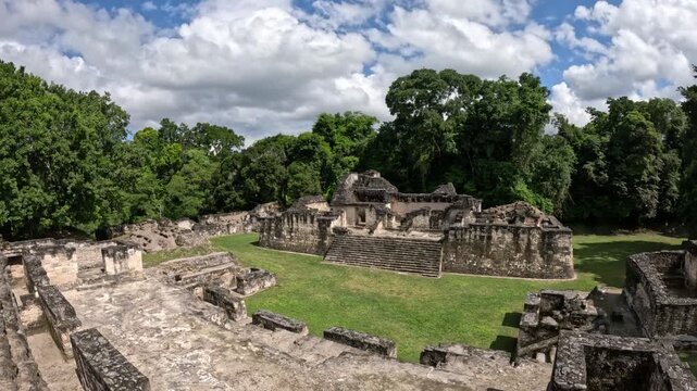 Cinematic ancient Mayan temples rising above the jungle in Tikal National Park Guatemala, epic archaeological travel footage Central America