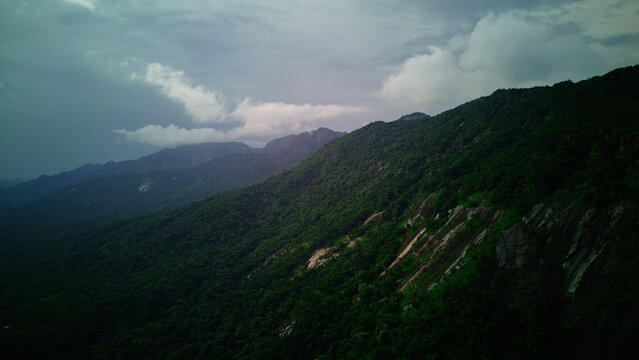 Aerial view of lush green mountains meeting the stormy skies, Anantagiri, Andhra Pradesh, India.