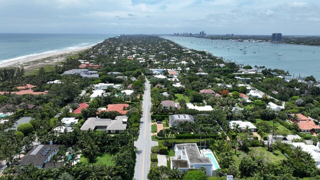 Aerial view of the town with its neat rows of houses, bordered by the tranquil ocean and the bay, Palm Beach, Florida, United States.