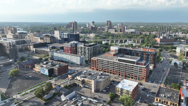 Aerial view of the city's buildings and streets blend under a soft sky, with a bridge far away, Minneapolis, Minnesota, United States.