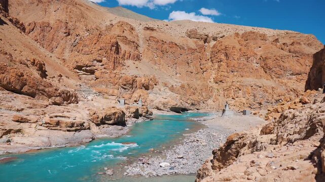 Blue Tsarap chu river flowing in the mountain valley of Zanskar as seen during the trek to Phugtal Monastery in Zanskar, Ladakh, India. Nature landscape. Travel and holidays concept.