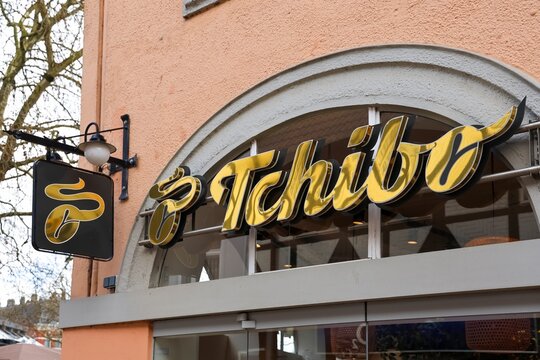 Neumuenster, Germany - 29. March 2026: Tchibo store sign with golden lettering