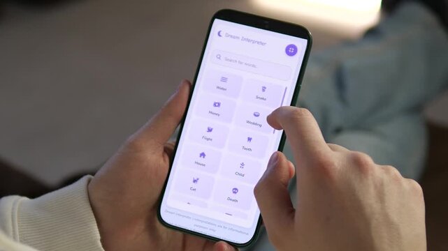 Authentic hand-held shot of a person using a mobile dream analyzer. Highlights smooth navigation and clean aesthetic. Versatile footage for app marketing, everyday tech usage, and personal growth