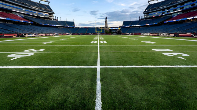 Empty American Football Stadium Field with Yard Lines and Goal Posts at Sunset