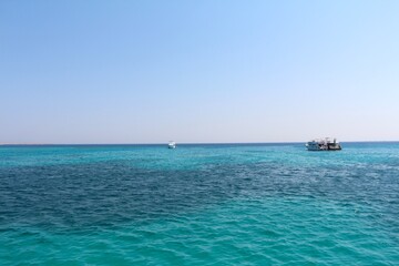 Fototapeta premium Tropical Ocean with Boats Under a Clear Sky. High quality photo