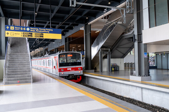 Jakarta, Indonesia - March 24, 2026: KAI Commuter train at Tanah Abang Station platform in Jakarta, with route signage for Serpong and Rangkasbitung lines.