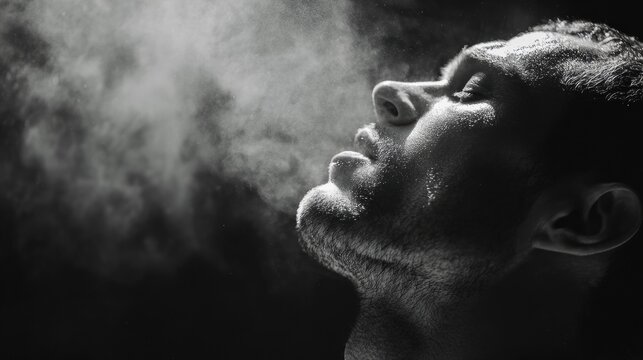 Focused athletic exhale. Male competitor showing concentration during intense physical exertion. Athlete demonstrating resilience and focus through deliberate breathing after vigorous exercise