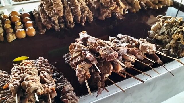 Various kinds of satay sticks in gray containers. One of tradisional food from Central Java, Indonesia. Footage. 