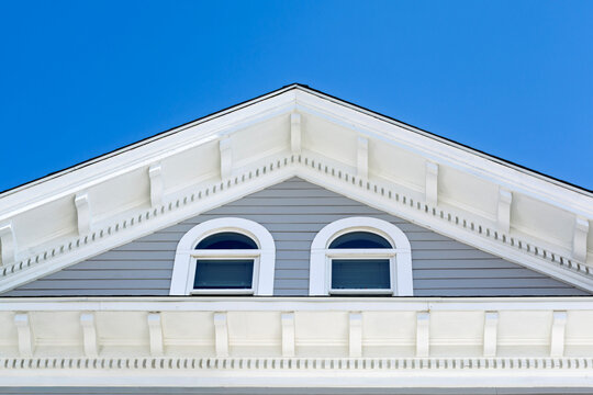Arched attic windows and decorative gable corbels on an elegant house in Boston Massachusetts

