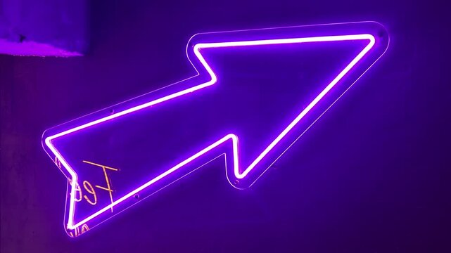 Colorful neon sign with arrow directs attention in energetic atmosphere