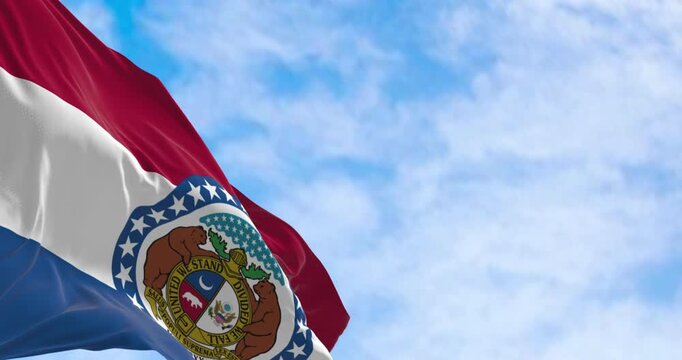 Missouri state flag waving on a clear day