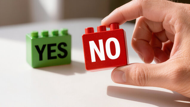 Hand Holding Red 'NO' Block with Green 'YES' Block in Background Decision Concept
