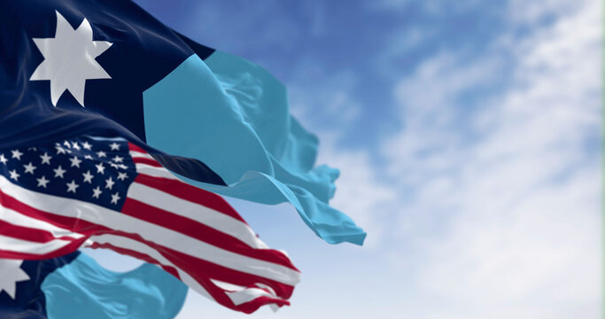 Close-up of Minnesota new state flags waving with the american flag on a clear day