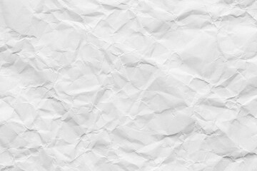Fototapeta premium Crumpled white paper texture background, Top view of wrinkled paper sheet,macro,Close-up of a white crumpled paper texture background. Highly detailed wrinkled surface of empty paper sheet with shadow