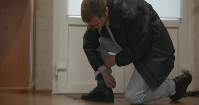 Man and child put on footwear winter shoes. 4K 10-bit