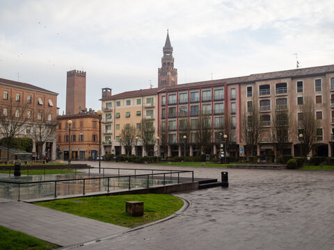 Piazza Marconi in Cremona presenting the Violin Museum and the Helidon Xhixha Stradivarius Violin monument, with the Torrazzo tower rising above the historic buildings
