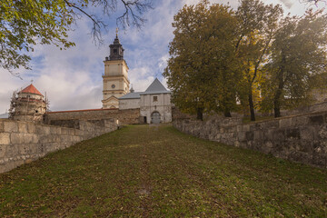 Naklejka premium Ancient Dominican monastery with bell tower and Virgin Mary column in Pidkamin