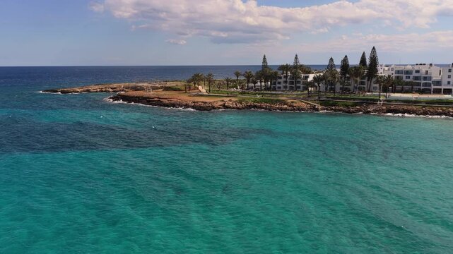Aerial drone view of Fig Tree beach and landscaped promenade along the coast of Protaras, Cyprus