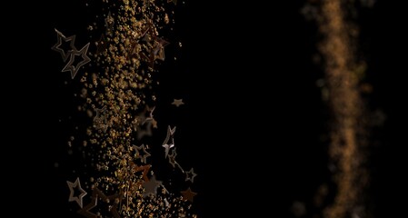 Dynamic image of golden star particles cascading down on a black background, representing elegance and celebration. © vegefox.com