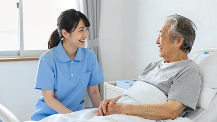 Fototapeta premium Cute, ponytail female caregiver laughing with elderly person sitting up in bed, smiling, generative AI