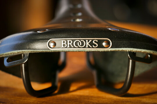 Brooks B17 standard black leather bicycle saddle on wooden table, rear view