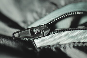 A close-up view of a zipper on a casual jacket, useful for fashion or outdoor themes © Fotograf