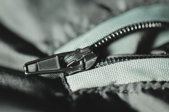 A close-up view of a zipper on a casual jacket, useful for fashion or outdoor themes