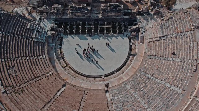 Aerial views of the Great Theatre of Ephesus in Izmir, Turkey. Ancient stone seating, Roman stage ruins and visitors reveal the monumental scale of this historic archaeological landmark.