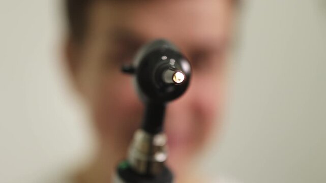 ENT doctor. Doctor's appointment. Flashlight. Slow motion. . High quality 4k footage