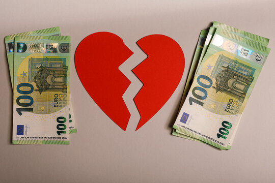 Concept image of a broken heart with euro banknotes, symbolizing financial difficulties related to r