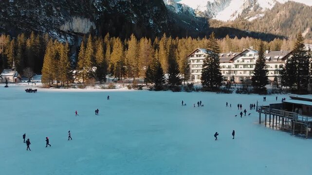 Braies Lake blotted in winter, aerial view from drone, Italian Alps