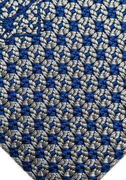 Intricate blue and silver thread embroidery creates a repeating geometric pattern on a fabric surface.