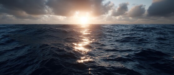 Obraz premium Seascape view showing gentle waves and sunset sky over the ocean with clouds at sunrise captured from above near the water's surface