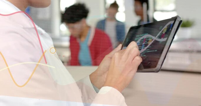 Diverse team watching adult woman wearing white lab coat using tablet displaying DNA helix at bench
