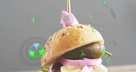 Naklejka premium Displaying seeded slider topped with wooden skewer and pink flag in studio, with green AR icons