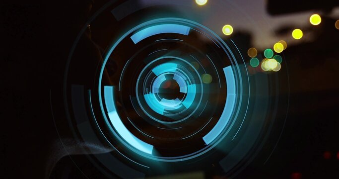 Glowing central cyan teal concentric lens showing segmented arcs, lines in low light with bokeh