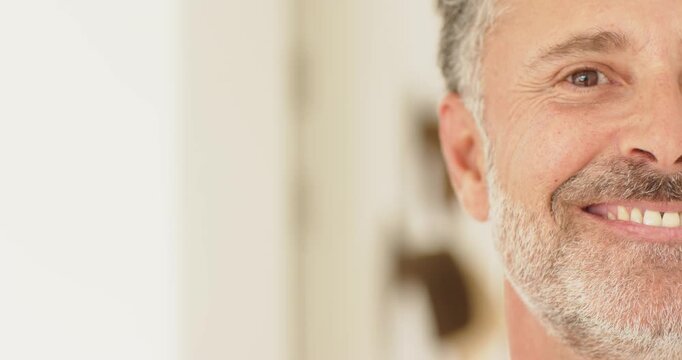 Mature male smiling while camera filming frames in hallway with shirt, trim and hooks, copy space