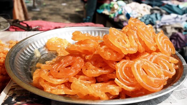 jalebis displayed for sell in a street food stall in a local fair